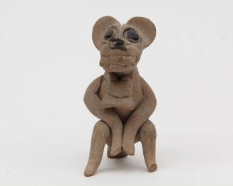 Whistle in the form of a feline-masked seated figure