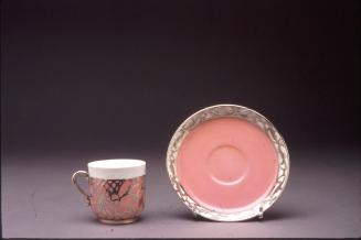 Cup and saucer with silver overlay