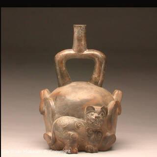 Stirrup-spout effigy bottle with feline and cactus