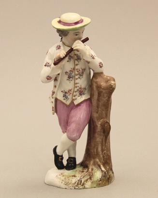 Figure of a boy playing a flute