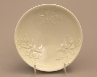 Saucer moulded with prunus design